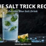 Glass of blue salt trick drink with lemon and mint beside Persian blue salt crystals