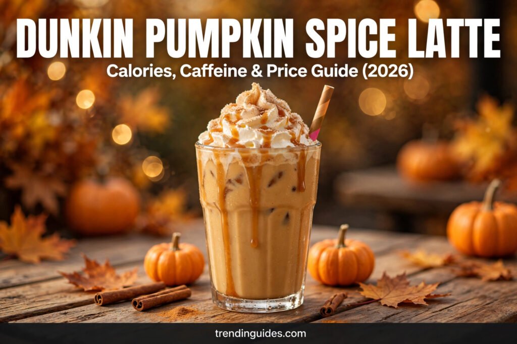 Iced pumpkin spice latte with whipped cream and caramel drizzle on a wooden café table with small pumpkins