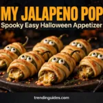 Mummy jalapeno poppers with candy eyes on a dark Halloween platter