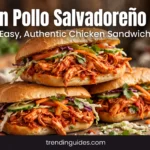 Pan con pollo Salvadoran chicken sandwiches stacked on a board
